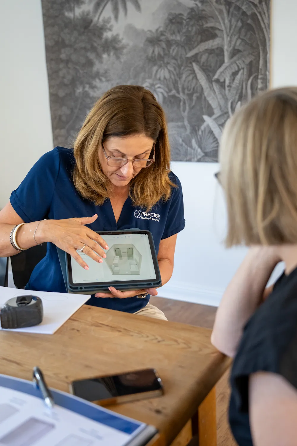 Anne, interior designer and estimator, consulting with a client