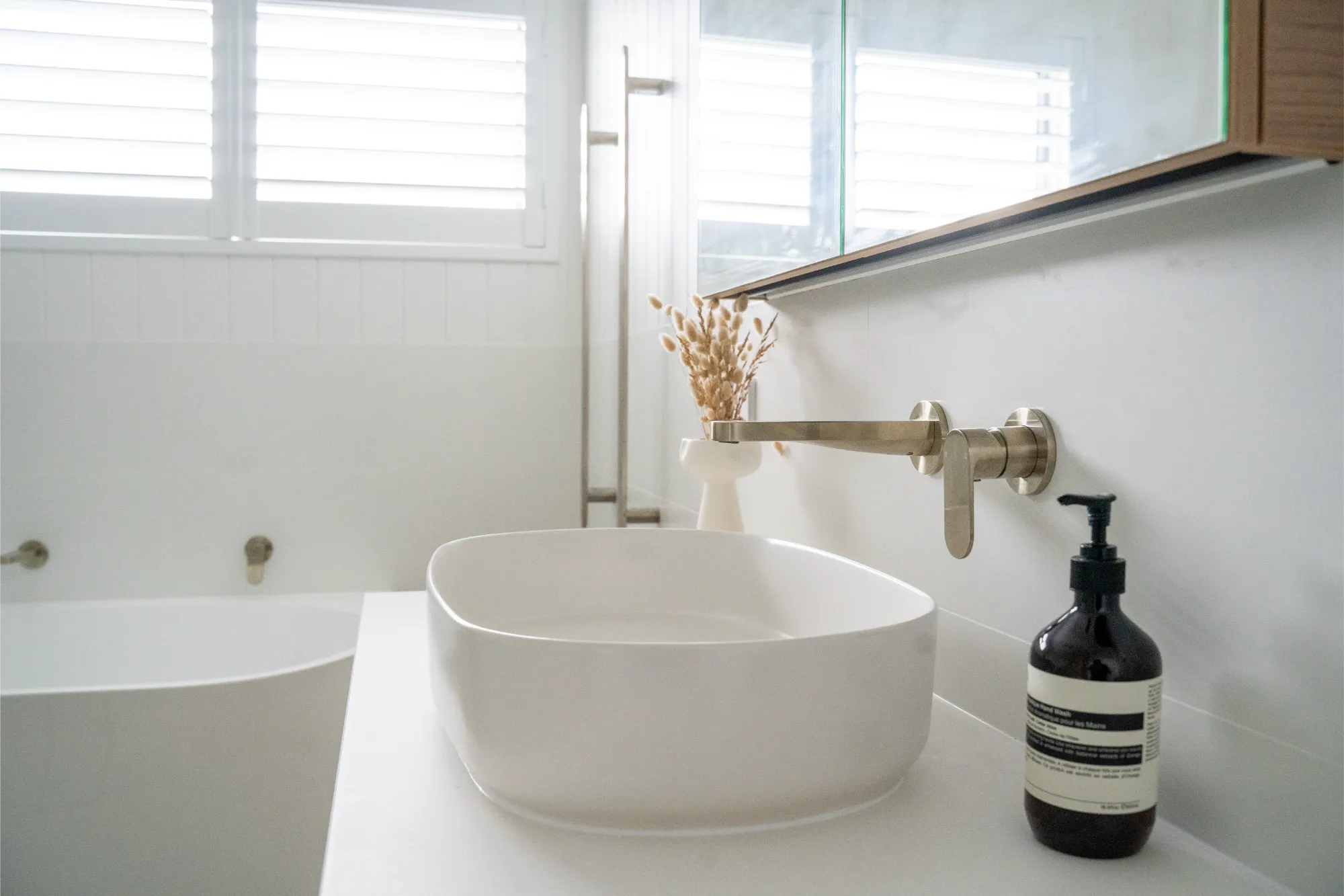 Bright bathroom with vessel sink and brushed gold tapware