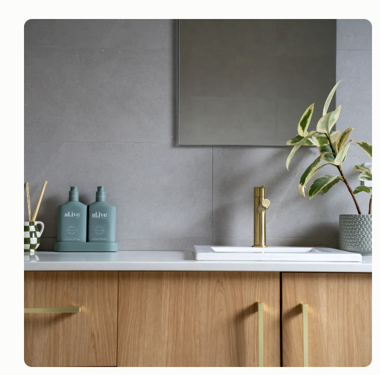 Modern oak vanity with gold tapware and accessories