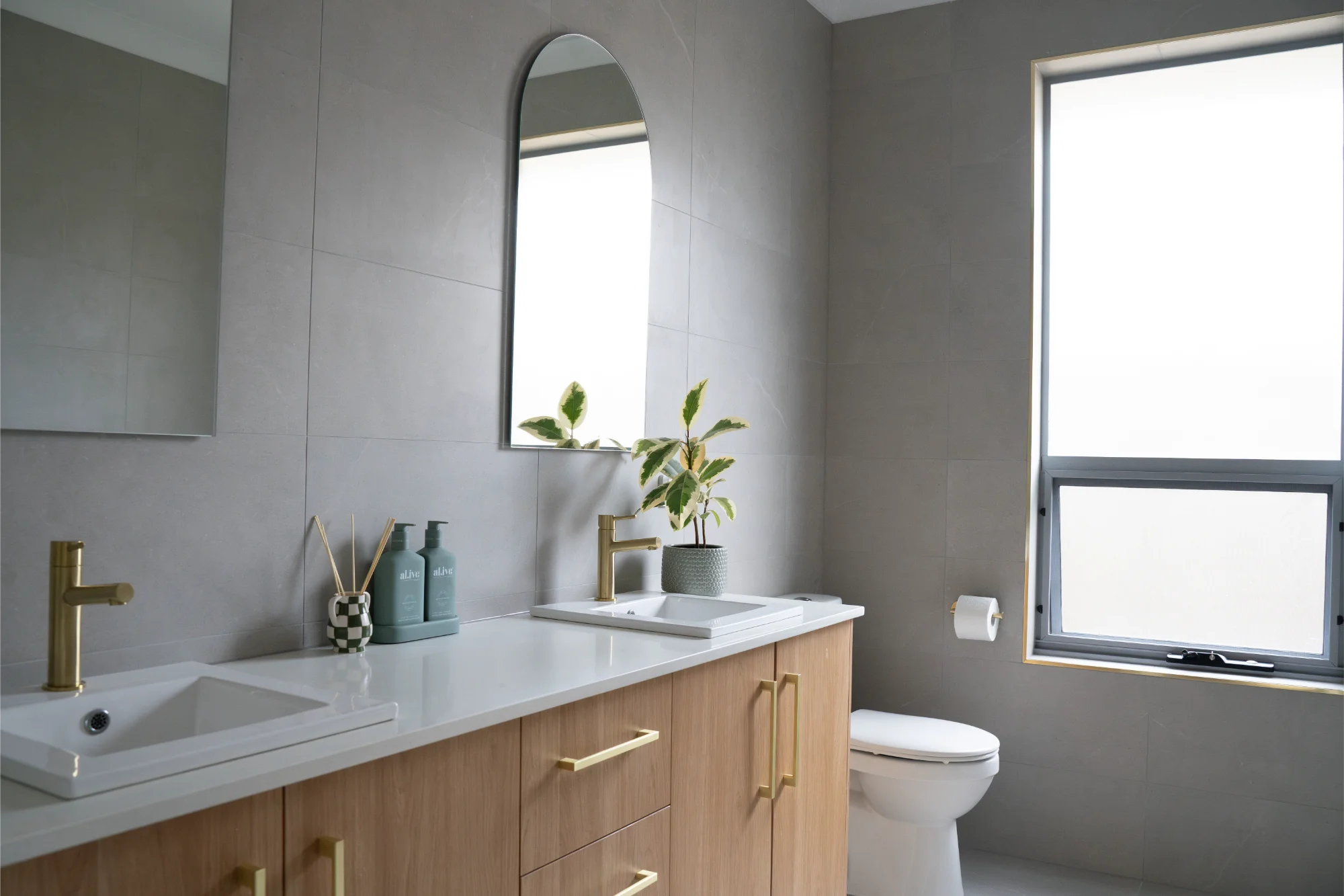 Modern bathroom with timber vanity and grey tiles