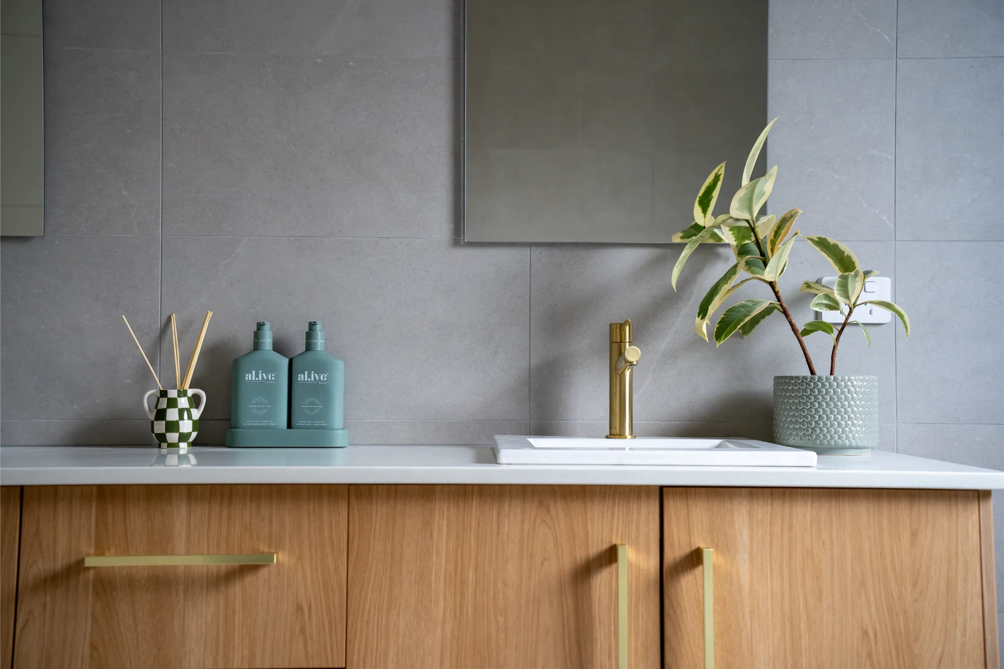 Modern bathroom with timber vanity and grey tiles